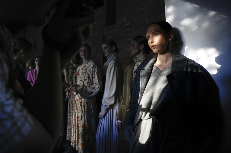 Russia Fashion Week Models display a collection by a group of Russian designers of the Moscow Art-Industrial Institute, during the Fashion Week at Zaryadye Park with the Spasskaya Tower and St. Basil's Cathedral on the left in background near Red Square in Moscow, Russia, Tuesday, June 21, 2022. (AP Photo/Alexander Zemlianichenko)