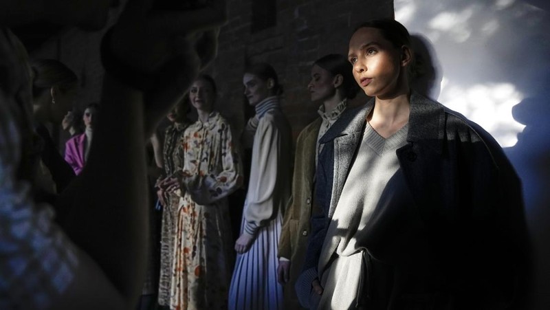 Models display a collection by a group of Russian designers of the Moscow Art-Industrial Institute, during the Fashion Week at Zaryadye Park with the Spasskaya Tower and St. Basil's Cathedral on the left in background near Red Square in Moscow, Russia, Tuesday, June 21, 2022. (AP Photo/Alexander Zemlianichenko)