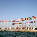 A general view shows flags of the qualified countries for the 2022 World Cup in the Qatari capital Doha during a flag-raising ceremony of the last remaining countries to qualify, on June 16, 2022. (Photo by Mustafa ABUMUNES / AFP) (Photo by MUSTAFA A