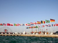 A general view shows flags of the qualified countries for the 2022 World Cup in the Qatari capital Doha during a flag-raising ceremony of the last remaining countries to qualify, on June 16, 2022. (Photo by Mustafa ABUMUNES / AFP) (Photo by MUSTAFA A