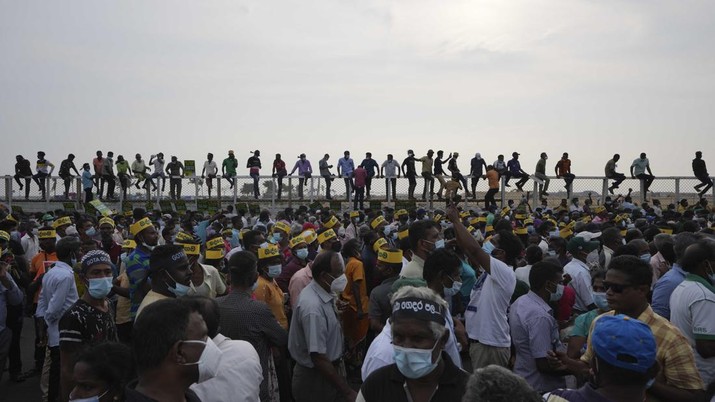 FILE- Supporters of Sri Lanka's main opposition gather for a protest as the country suffers one of the worst economic crises in history, outside the president's office in Colombo, Sri Lanka, Tuesday, March 15, 2022. (AP Photo/Eranga Jayawardena, File)