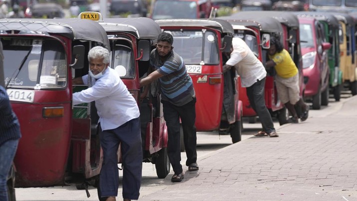 Lebanon Sri Lanka Collapse File- Sri Lankan auto rickshaw drivers queue up to buy petrol near a fuel station in Colombo, Sri Lanka, Wednesday, April 13, 2022. Sri Lanka is now almost without gasoline and faces an acute shortage of other fuels. Authorities have announced nationwide power cuts of up to four hours a day and asked state employees not to work on Fridays, except for those needed for essential services. (AP Photo/Eranga Jayawardena, File)
