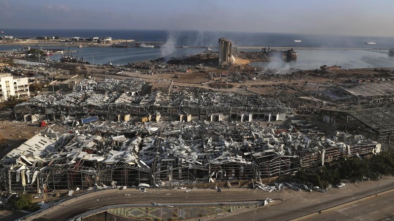 FILE- This photo shows a general view of the scene of an explosion that hit the seaport of Beirut, Lebanon, Wednesday, Aug. 5, 2020. On Aug. 4, 2020, a catastrophic explosion struck Beirut's port, killing at least 216 people and wrecking large parts of the city. The blast, widely considered one of the largest non-nuclear explosions in history, was caused by the detonation of hundreds of tons of ammonium nitrate that was stored in a warehouse for years. (AP Photo/Bilal Hussein, File)