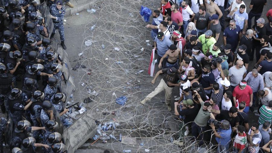 FILE- This photo shows a general view of the scene of an explosion that hit the seaport of Beirut, Lebanon, Wednesday, Aug. 5, 2020. On Aug. 4, 2020, a catastrophic explosion struck Beirut's port, killing at least 216 people and wrecking large parts of the city. The blast, widely considered one of the largest non-nuclear explosions in history, was caused by the detonation of hundreds of tons of ammonium nitrate that was stored in a warehouse for years. (AP Photo/Bilal Hussein, File)