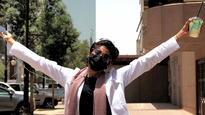Perempuan Rambut Pendek di Saudi Safi, a 26-year-old Saudi physician, poses for a photo with her short hair near the Kingdom Centre skyscraper in the centre of Saudi Arabia's capital Riyadh on June 19, 2022. - When Saudi doctor Safi took a new job at a hospital in the capital, she decided to offset her standard white lab coat with a look she once would have considered dramatic. Walking into a Riyadh salon, she ordered the hairdresser to chop her long, wavy locks all the way up to her neck, a style increasingly in vogue among working women in the conservative kingdom. The haircut - known locally by the English word