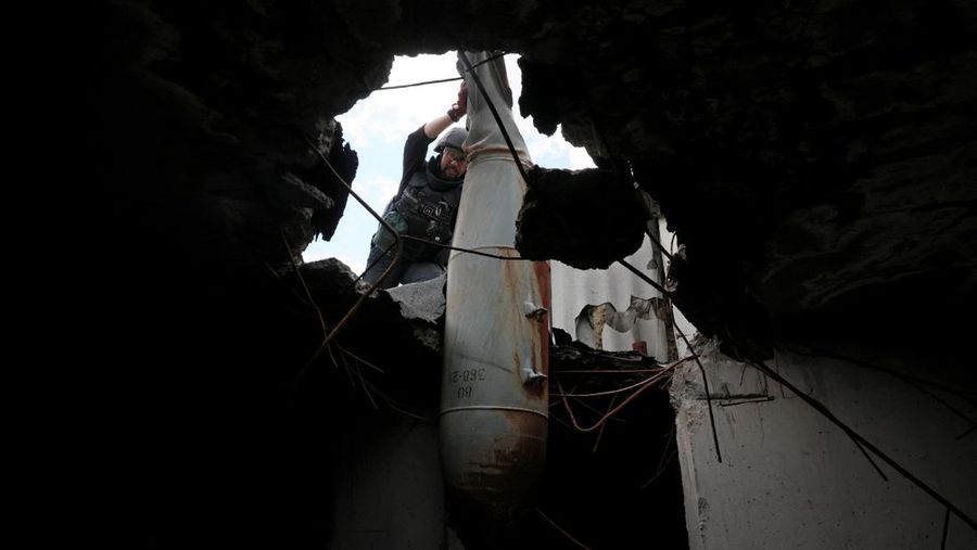 Members of a specialised team that defuses and removes explosives, bombs, mines and other munitions remove a defused 500kg bomb that did not detonate when it landed on an apartment building in March, in the Saltivka neighbourhood, as Russia’s attack on Ukraine continues, in Kharkiv, Ukraine, June 23, 2022. REUTERS/Leah Millis