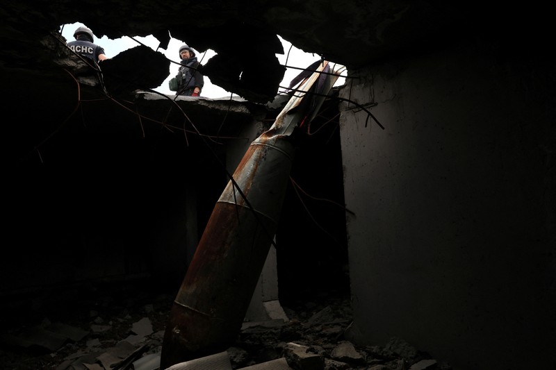 Members of a specialised team that defuses and removes explosives, bombs, mines and other munitions remove a defused 500kg bomb that did not detonate when it landed on an apartment building in March, in the Saltivka neighbourhood, as Russia’s attack on Ukraine continues, in Kharkiv, Ukraine, June 23, 2022. REUTERS/Leah Millis