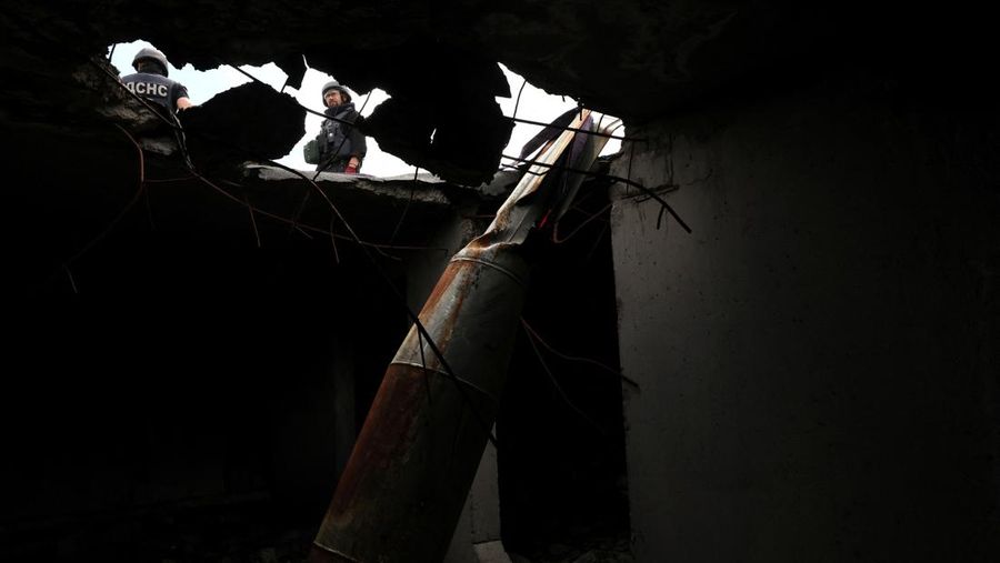 Members of a specialised team that defuses and removes explosives, bombs, mines and other munitions remove a defused 500kg bomb that did not detonate when it landed on an apartment building in March, in the Saltivka neighbourhood, as Russia’s attack on Ukraine continues, in Kharkiv, Ukraine, June 23, 2022. REUTERS/Leah Millis