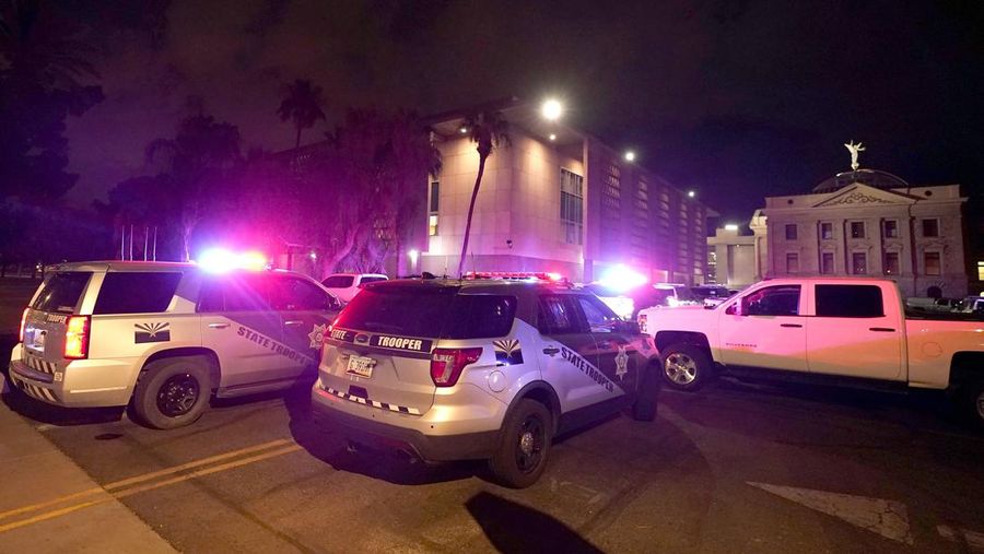 A large number of police surround the Arizona Capitol after protesters reached the front of the AZ Senate building following the Supreme Court's decision to overturn Roe v. Wade Friday, June 24, 2022, in Phoenix. (AP Photo/Ross D. Franklin)