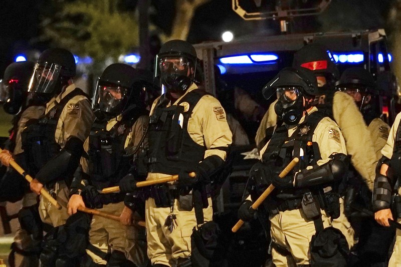 Supreme Court Abortion Arizona A large number of police surround the Arizona Capitol after protesters reached the front of the AZ Senate building following the Supreme Court's decision to overturn Roe v. Wade Friday, June 24, 2022, in Phoenix. (AP Photo/Ross D. Franklin)