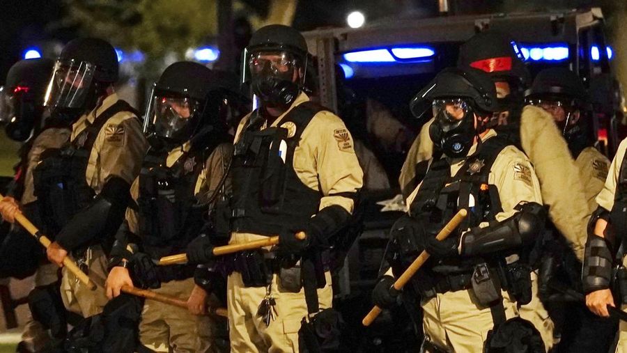 A large number of police surround the Arizona Capitol after protesters reached the front of the AZ Senate building following the Supreme Court's decision to overturn Roe v. Wade Friday, June 24, 2022, in Phoenix. (AP Photo/Ross D. Franklin)