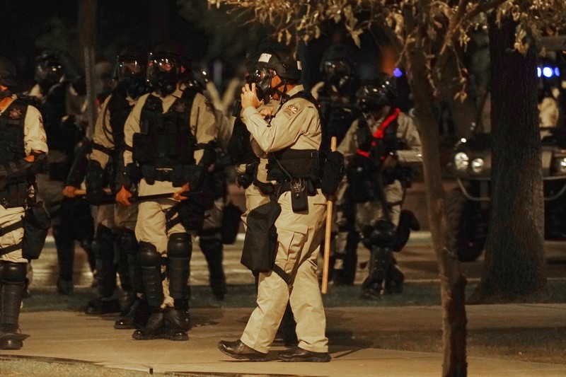 Supreme Court Abortion Arizona A large number of police surround the Arizona Capitol after protesters reached the front of the AZ Senate building following the Supreme Court's decision to overturn Roe v. Wade Friday, June 24, 2022, in Phoenix. (AP Photo/Ross D. Franklin)