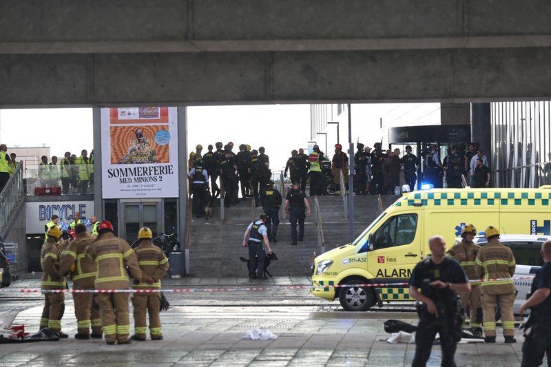 Polisi bersenjata berjaga di lokasi penembakan di pusat perbelanjaan Fields di Kopenhagen, Denmark, Minggu (3/7/2022). Polisi menangkap seorang pria berusia 22 tahun atas kejadian penembakan yang menyebabkan beberapa korban tewas dan beberapa terluka. (Ritzau Scanpix/Olafur Steinar Gestsson  via REUTERS)