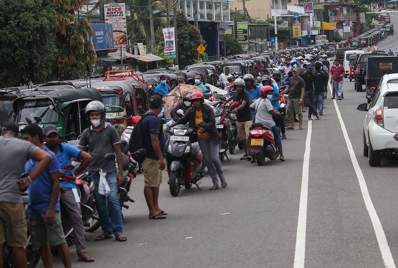 Warga memasak makanan dengan tungku kayu di luar rumah susunnya di Kolombo, Sri Lanka, Senin (4/7/2022). Sri Lanka kehabisan bahan bakar bensin dan diesel usai pengiriman pasokan ditunda tanpa kepastian. (Photo by Thilina Kaluthotage/NurPhoto via Getty Images)