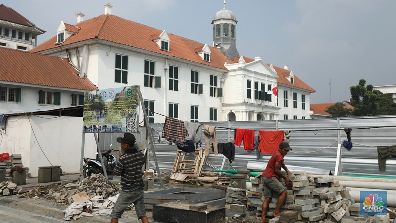 Revitalisasi Kota Tua Pekerja menyelesaikan proyek revitalisasi pedestrian di kawasan Kota Tua, Jakarta, Kamis (7/7/2022). Dinas Bina Marga Provinsi DKI Jakarta mengemukakan pengerjaan revitalisasi trotoar di Kota Tua, Taman Sari, Jakarta Barat, sudah mencapai 80 persen dan direncanakan selesai di akhir bulan Juli 2022. (CNBC Indoesia/ Tri Susilo)