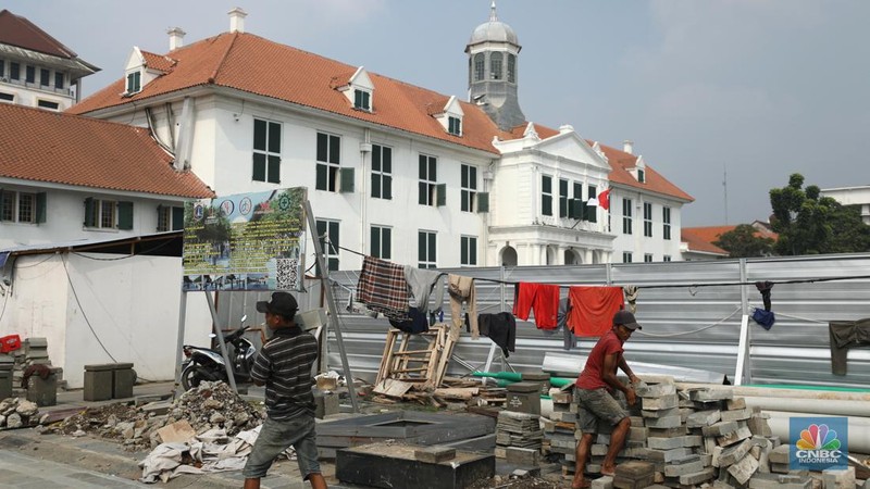 Pekerja menyelesaikan proyek revitalisasi pedestrian di kawasan Kota Tua, Jakarta, Kamis  (7/7/2022). Dinas Bina Marga Provinsi DKI Jakarta mengemukakan pengerjaan revitalisasi trotoar di Kota Tua, Taman Sari, Jakarta Barat, sudah mencapai 80 persen dan direncanakan selesai di akhir bulan Juli 2022. (CNBC Indoesia/ Tri Susilo)