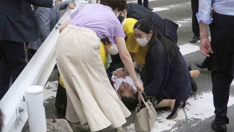 Former Japanese prime minister Shinzo Abe lies on the ground after apparent shooting during an election campaign for the July 10, 2022 Upper House election, in Nara, western Japan July 8, 2022. in this photo taken by Kyodo. Mandatory credit Kyodo via REUTERS ATTENTION EDITORS - THIS IMAGE WAS PROVIDED BY A THIRD PARTY. MANDATORY CREDIT. JAPAN OUT. NO COMMERCIAL OR EDITORIAL SALES IN JAPAN.