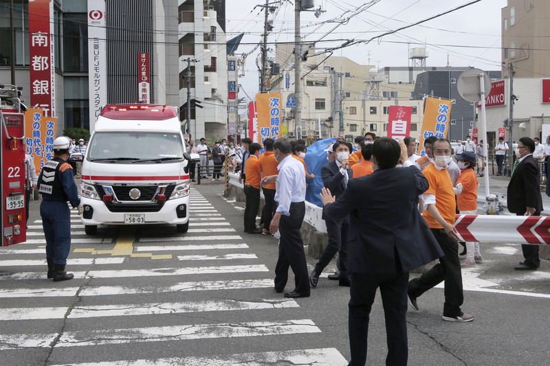 Former Japanese prime minister Shinzo Abe lies on the ground after apparent shooting during an election campaign for the July 10, 2022 Upper House election, in Nara, western Japan July 8, 2022. in this photo taken by Kyodo. Mandatory credit Kyodo via REUTERS ATTENTION EDITORS - THIS IMAGE WAS PROVIDED BY A THIRD PARTY. MANDATORY CREDIT. JAPAN OUT. NO COMMERCIAL OR EDITORIAL SALES IN JAPAN.