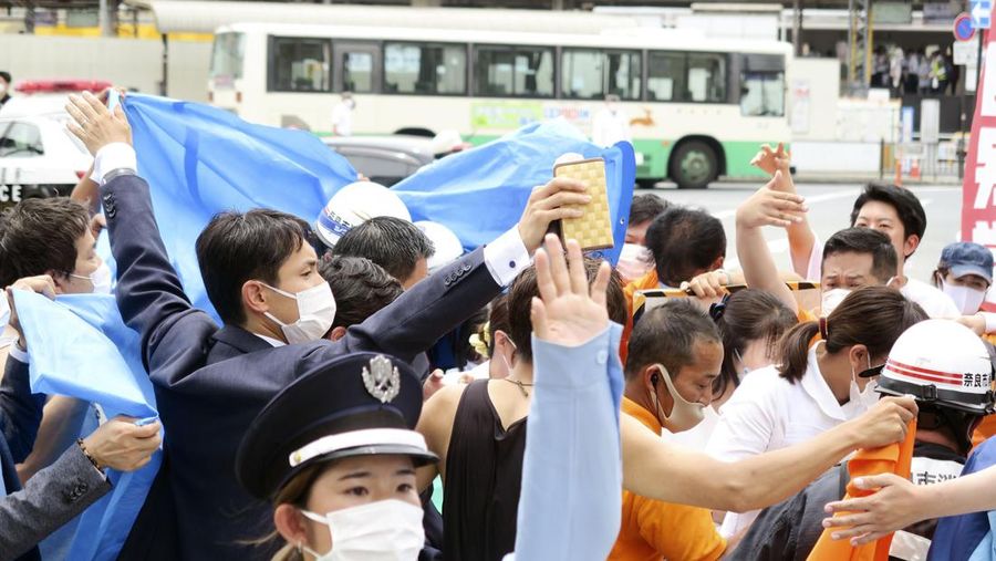 Former Japanese prime minister Shinzo Abe lies on the ground after apparent shooting during an election campaign for the July 10, 2022 Upper House election, in Nara, western Japan July 8, 2022. in this photo taken by Kyodo. Mandatory credit Kyodo via REUTERS ATTENTION EDITORS - THIS IMAGE WAS PROVIDED BY A THIRD PARTY. MANDATORY CREDIT. JAPAN OUT. NO COMMERCIAL OR EDITORIAL SALES IN JAPAN.