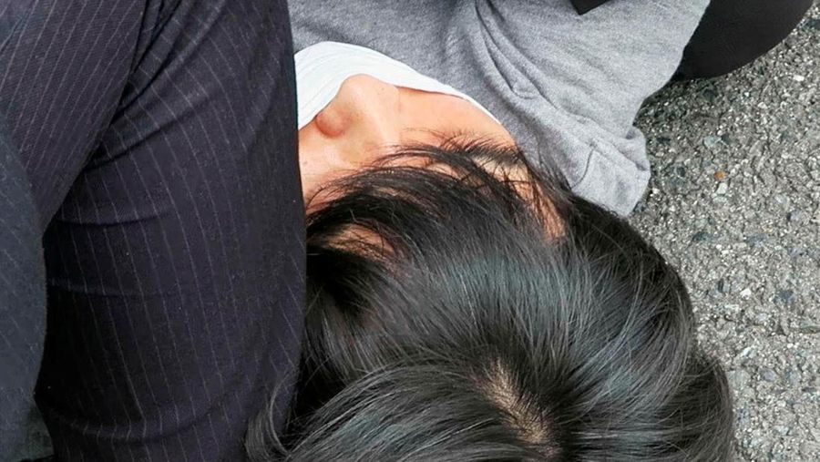 Former Japanese prime minister Shinzo Abe lies on the ground after apparent shooting during an election campaign for the July 10, 2022 Upper House election, in Nara, western Japan July 8, 2022. in this photo taken by Kyodo. Mandatory credit Kyodo via REUTERS ATTENTION EDITORS - THIS IMAGE WAS PROVIDED BY A THIRD PARTY. MANDATORY CREDIT. JAPAN OUT. NO COMMERCIAL OR EDITORIAL SALES IN JAPAN.