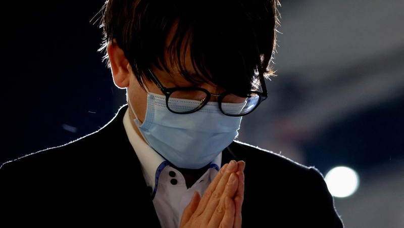 People pray at a makeshift memorial at the scene where the former Prime Minister Shinzo Abe was shot while delivering his speech to support the Liberal Democratic Party's candidate during an election campaign in Nara, Friday, July 8, 2022.  Abe, a divisive arch-conservative and one of his nation's most powerful and influential figures, has died after being shot during a campaign speech Friday in western Japan, hospital officials said.(Kyodo News via AP)