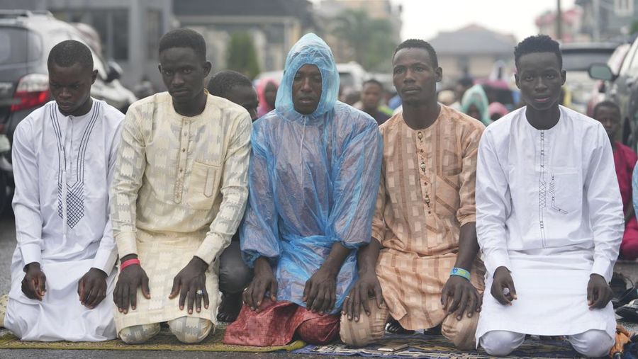 Muslim pilgrims walk to cast stones at a pillar in the symbolic stoning of the devil, during the last rite of the annual hajj, and the first day of Eid al-Adha, in Mina near the city of Mecca, Saudi Arabia, Saturday, July 9, 2022. (AP Photo/Amr Nabil)