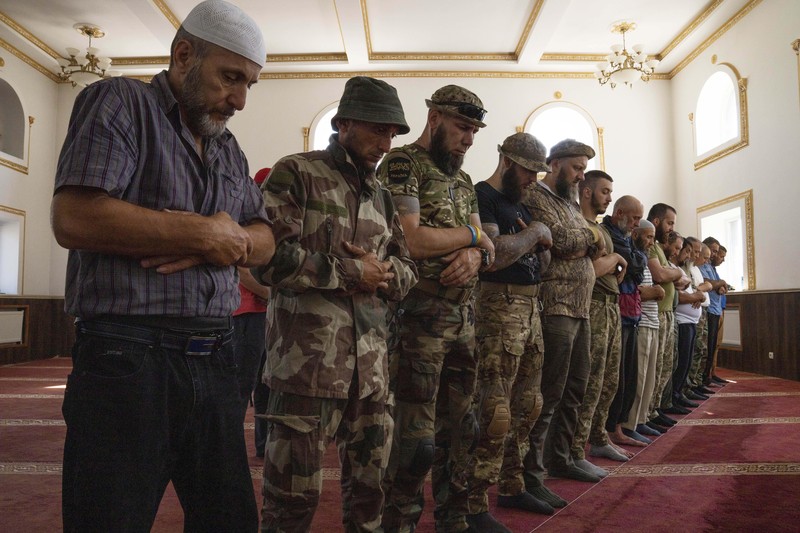 Russia Ukraine War Eid al-Adha Former Mufti-turned-fighter Sheikh Said Ismahilov, right, leads Muslim soldiers during prayers on the first day of Eid al-Adha, in Medina Mosque, Konstantinovka, eastern Ukraine, Saturday, July 9, 2022. Muslims around the world celebrate Eid al-Adha by sacrificing animals to commemorate the prophet Ibrahim's faith in being willing to sacrifice his son. (AP Photo/Nariman El-Mofty)