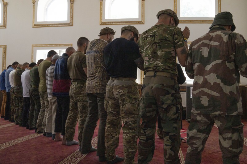 Russia Ukraine War Eid al-Adha Former Mufti-turned-fighter Sheikh Said Ismahilov, right, leads Muslim soldiers during prayers on the first day of Eid al-Adha, in Medina Mosque, Konstantinovka, eastern Ukraine, Saturday, July 9, 2022. Muslims around the world celebrate Eid al-Adha by sacrificing animals to commemorate the prophet Ibrahim's faith in being willing to sacrifice his son. (AP Photo/Nariman El-Mofty)