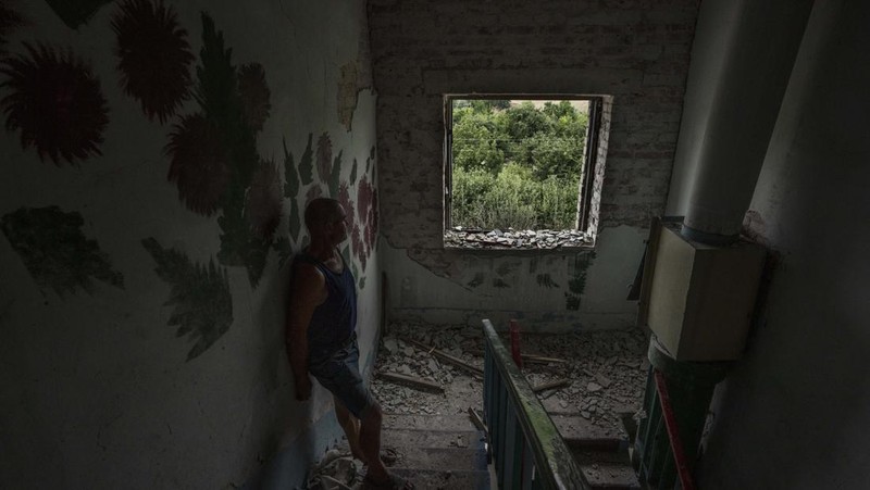 A sofa chair is seen in what is left standing in the aftermath of a Russian rocket that hit an apartment residential block, in Chasiv Yar, Donetsk region, eastern Ukraine, Sunday, July 10, 2022. At least 15 people were killed and more than 20 people may still be trapped in the rubble, officials said Sunday. (AP Photo/Nariman El-Mofty)