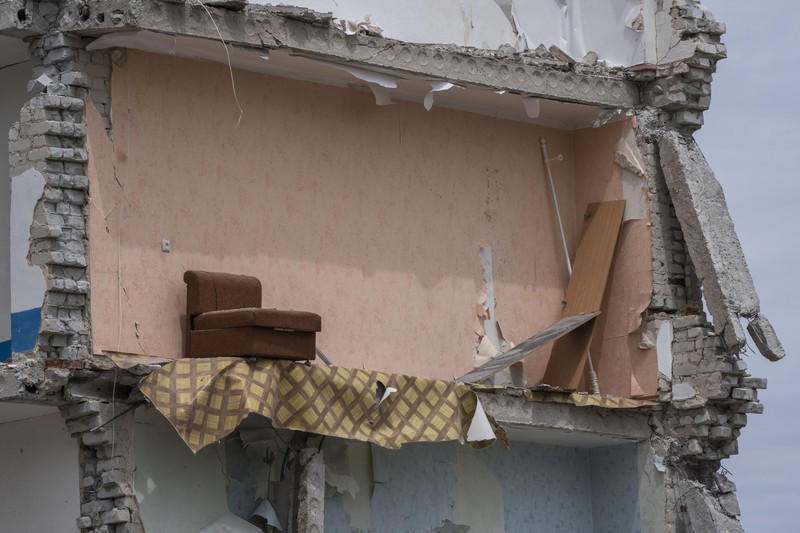 Russia Ukraine War A sofa chair is seen in what is left standing in the aftermath of a Russian rocket that hit an apartment residential block, in Chasiv Yar, Donetsk region, eastern Ukraine, Sunday, July 10, 2022. At least 15 people were killed and more than 20 people may still be trapped in the rubble, officials said Sunday. (AP Photo/Nariman El-Mofty)