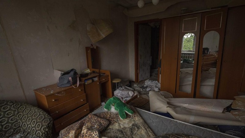 A sofa chair is seen in what is left standing in the aftermath of a Russian rocket that hit an apartment residential block, in Chasiv Yar, Donetsk region, eastern Ukraine, Sunday, July 10, 2022. At least 15 people were killed and more than 20 people may still be trapped in the rubble, officials said Sunday. (AP Photo/Nariman El-Mofty)