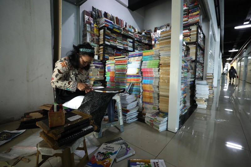 Sejumlah pedagang di toko buku Kenari, Jakarta merapikan buku pada rak di toko mereka masing-masing, Senin (11/7/2022). (CNBC Indonesia/Tri Susilo)