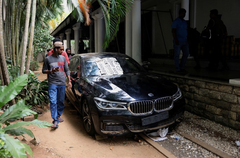 Demonstrators sleep on the President Gotabaya Rajapaksa's bed at the President's house, on the following day after demonstrators entered the building, after President Gotabaya Rajapaksa fled, amid the country's economic crisis, in Colombo, Sri Lanka July 10, 2022. REUTERS/Dinuka Liyanawatte