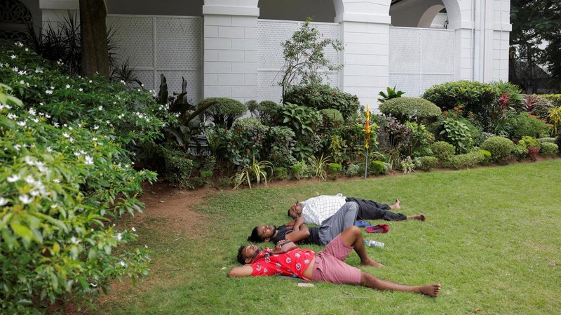 Demonstrators sleep on the President Gotabaya Rajapaksa's bed at the President's house, on the following day after demonstrators entered the building, after President Gotabaya Rajapaksa fled, amid the country's economic crisis, in Colombo, Sri Lanka July 10, 2022. REUTERS/Dinuka Liyanawatte