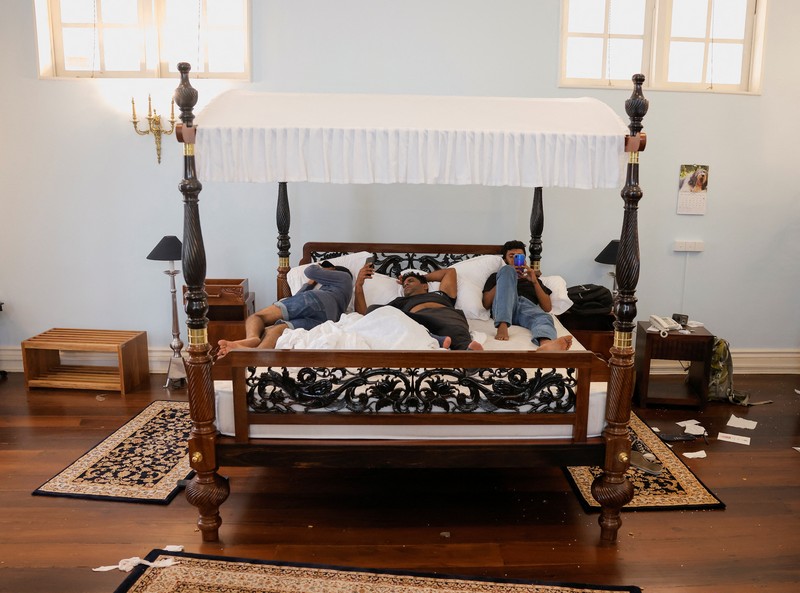 SRI LANKA-CRISIS/ Demonstrators sleep on the President Gotabaya Rajapaksa's bed at the President's house, on the following day after demonstrators entered the building, after President Gotabaya Rajapaksa fled, amid the country's economic crisis, in Colombo, Sri Lanka July 10, 2022. REUTERS/Dinuka Liyanawatte