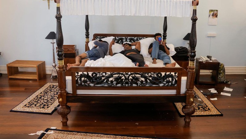 Demonstrators sleep on the President Gotabaya Rajapaksa's bed at the President's house, on the following day after demonstrators entered the building, after President Gotabaya Rajapaksa fled, amid the country's economic crisis, in Colombo, Sri Lanka July 10, 2022. REUTERS/Dinuka Liyanawatte