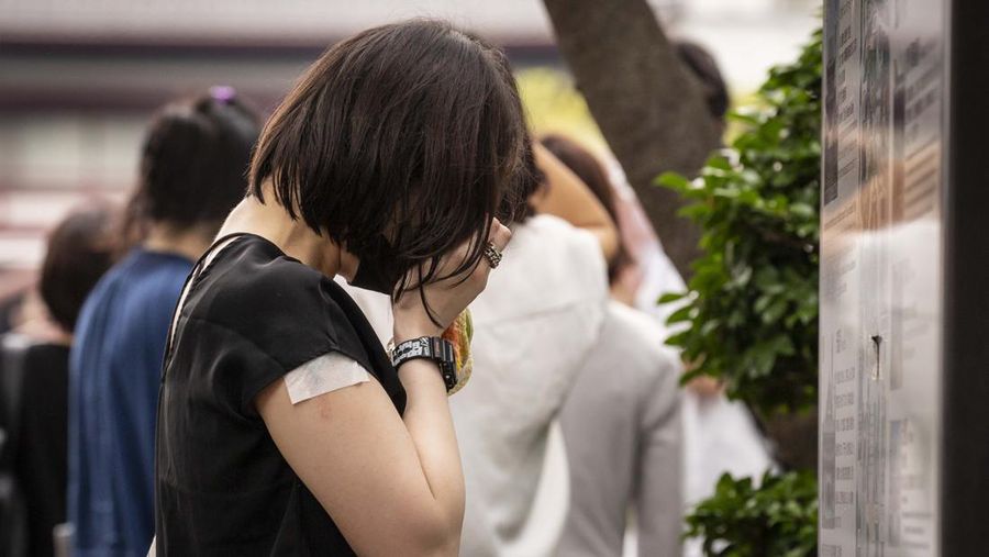 TOKYO, JAPAN - JULY 12: A woman reacts during the funeral for former Japanese Prime Minister Shinzo Abe at Zojoji temple on July 12, 2022 in Tokyo, Japan. Abe was assassinated as he was campaigning at a rally in Nara on Friday. A suspect was apprehended and taken into custody, and confessed to shooting Abe with an improvised homemade gun. The killing of Japan's longest-serving prime minister in a country where gun violence is extremely rare has shocked the nation and the world. (Photo by Yuichi Yamazaki/Getty Images)