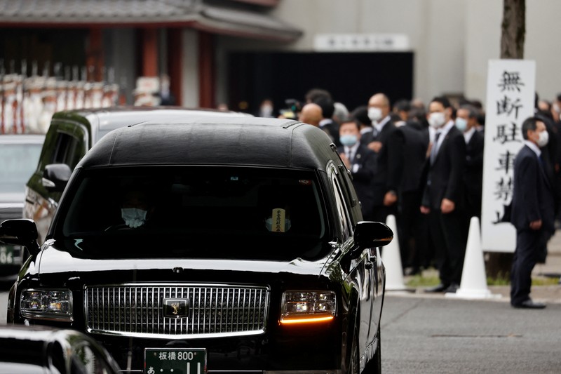 JAPAN-ABE/FUNERAL Akie Abe, wife of late former Japanese Prime Minister Shinzo Abe, who was shot while campaigning for a parliamentary election, sits in a vehicle carrying Abe's body, as she leaves after his funeral at Zojoji Temple in Tokyo, Japan July 12, 2022. REUTERS/Issei Kato