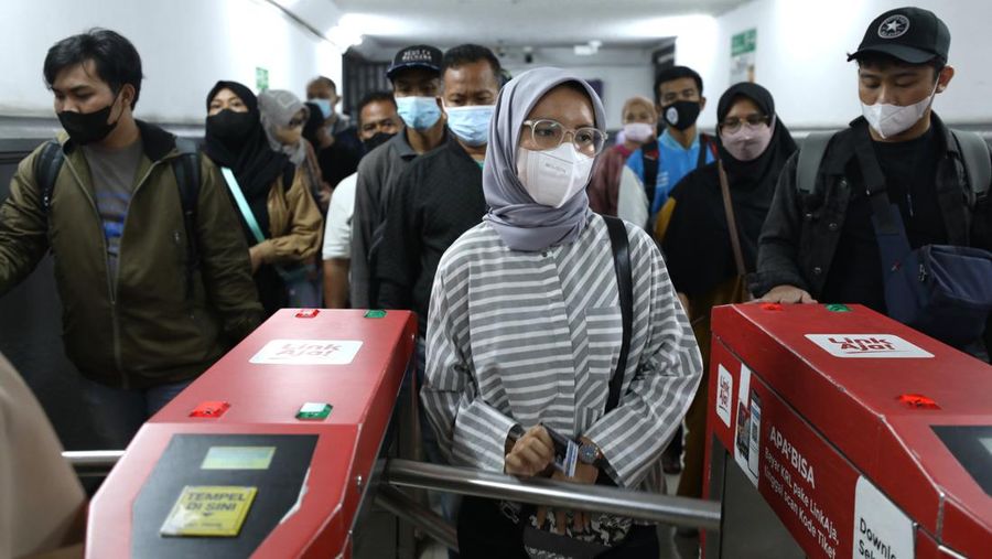 Sejumlah penumpang kereta KRL melakukan scan PeduliLindungi di Stasiun Pasar Senen, Jakarta, Selasa (12/7/2022). Pemerintah telah menerbitkan aturan perjalanan terbaru merespons kenaikan kasus COVID-19. Aturan-aturan perjalanan terbaru bakal mulai berlaku mulai 17 Juli 2022 mendatang. (CNBC Indonesia/Tri Susilo)