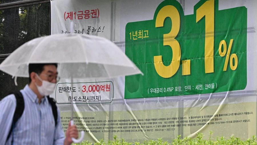 A man walks past an advertisement showing a bank's interest rate in Seoul on July 13, 2022, after South Korea's central bank delivered a historic half-point interest rate hike to tame fast-growing inflation. (Photo by Jung Yeon-je / AFP) (Photo by JUNG YEON-JE/AFP via Getty Images)
