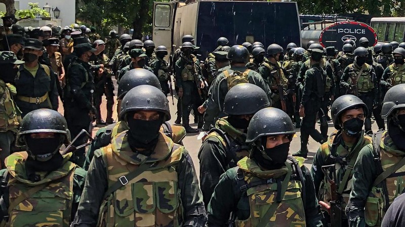 Police use teargas as Sri Lankan protesters storm the compound of prime minister Ranil Wickremesinghe 's office, demanding he resign after president Gotabaya Rajapaksa fled amid economic crisis in Colombo, Sri Lanka, Wednesday, July 13, 2022. (AP Photo/Rafiq Maqbool)