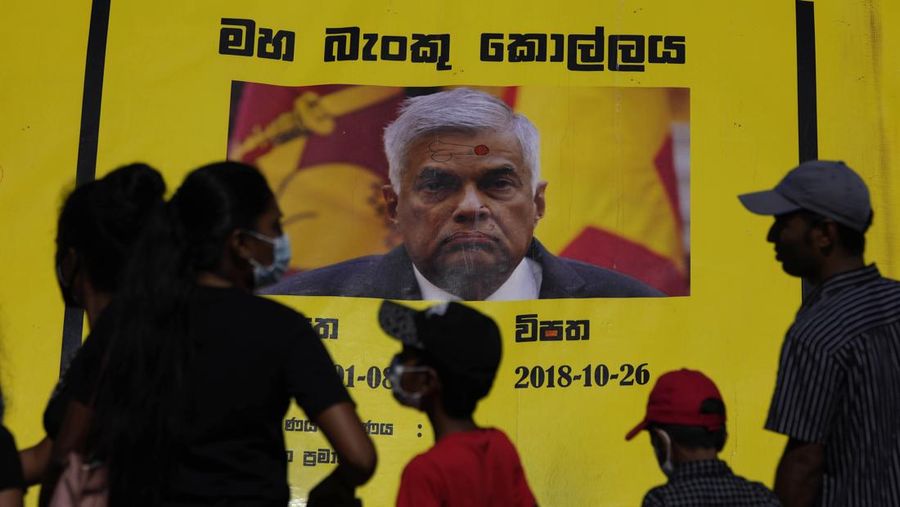 Sri Lanka police men patrol at the official residence of president Gotabaya Rajapaksa fourth days after it was stormed by anti government protesters in Colombo in Colombo, Sri Lanka, Wednesday, July 13, 2022. The president of Sri Lanka fled the country early Wednesday, July 13, days after protesters stormed his home and office and the official residence of his prime minister amid a monthslong economic crisis that triggered severe shortages of food and fuel.(AP Photo/Rafiq Maqbool)