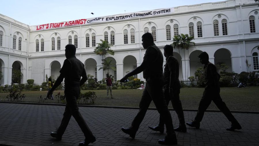 Sri Lanka police men patrol at the official residence of president Gotabaya Rajapaksa fourth days after it was stormed by anti government protesters in Colombo in Colombo, Sri Lanka, Wednesday, July 13, 2022. The president of Sri Lanka fled the country early Wednesday, July 13, days after protesters stormed his home and office and the official residence of his prime minister amid a monthslong economic crisis that triggered severe shortages of food and fuel.(AP Photo/Rafiq Maqbool)