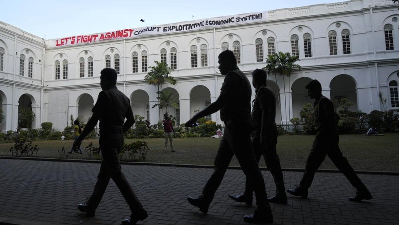 Sri Lanka police men patrol at the official residence of president Gotabaya Rajapaksa fourth days after it was stormed by anti government protesters in Colombo in Colombo, Sri Lanka, Wednesday, July 13, 2022. The president of Sri Lanka fled the country early Wednesday, July 13, days after protesters stormed his home and office and the official residence of his prime minister amid a monthslong economic crisis that triggered severe shortages of food and fuel.(AP Photo/Rafiq Maqbool)