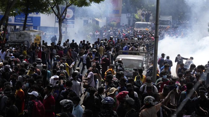 Police use teargas as Sri Lankan protesters storm the compound of prime minister Ranil Wickremesinghe 's office, demanding he resign after president Gotabaya Rajapaksa fled amid economic crisis in Colombo, Sri Lanka, Wednesday, July 13, 2022. (AP Photo/Rafiq Maqbool)