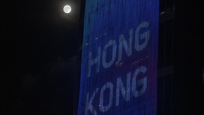 The moon next to a display on a building with Hong Kong on it on July 13, 2022 in Hong Kong, China. (Photo by Vernon Yuen/NurPhoto via Getty Images)