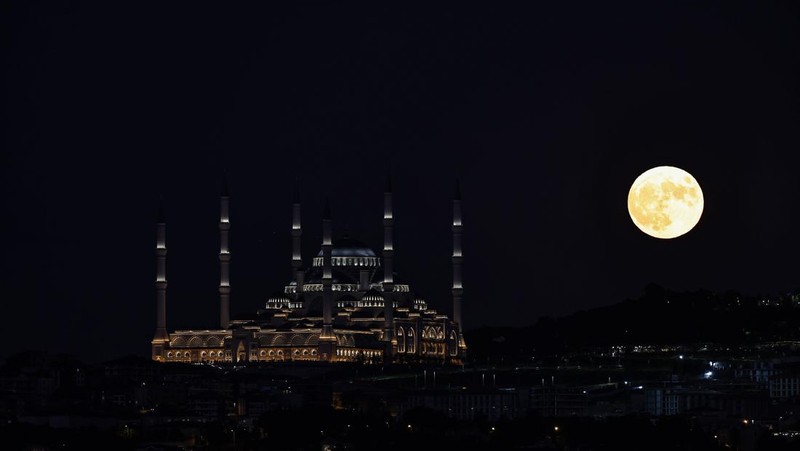 ISTANBUL, TURKIYE  - JULY 13: Super moon rises over Grand Camlica Mosque in Istanbul, Turkiye on July 13, 2022. (Photo by Ali Atmaca/Anadolu Agency via Getty Images)