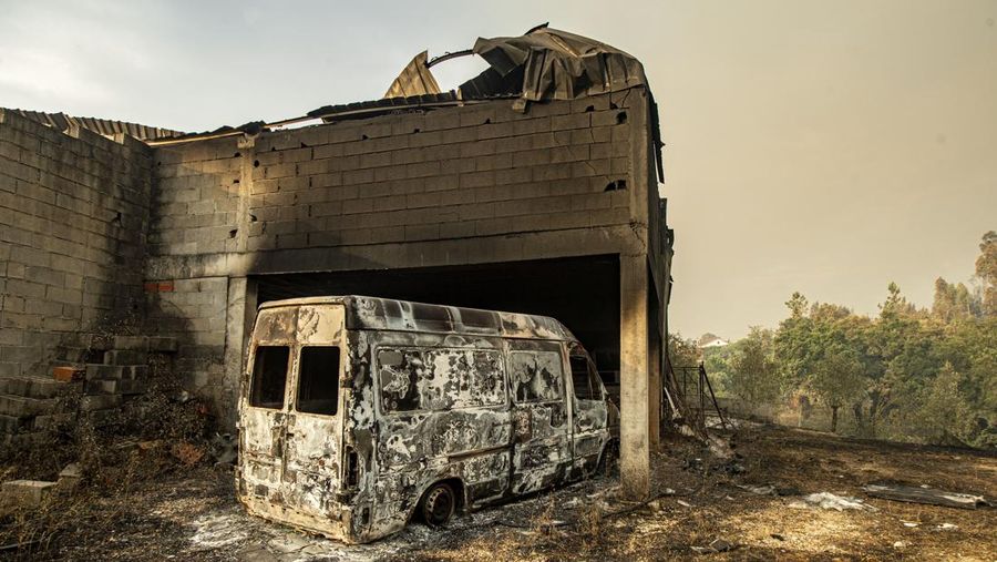 POMBAL, PORTUGAL - JULY 14: This photograph shows a burnt car on a carpentry company at Ansiao on July 14, 2022 in Pombal, Portugal. Wildfires have swept across the central part of the country amid temperatures exceeding 40 degrees celsius. (Photo by Octavio Passos/Getty Images)