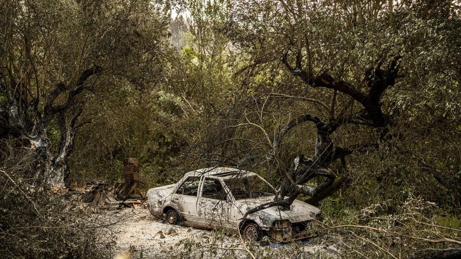 POMBAL, PORTUGAL - JULY 14: This photograph shows a burnt car on a carpentry company at Ansiao on July 14, 2022 in Pombal, Portugal. Wildfires have swept across the central part of the country amid temperatures exceeding 40 degrees celsius. (Photo by Octavio Passos/Getty Images)
