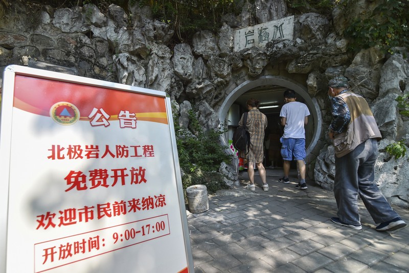 China Extreme Temperatures A sign announces the opening hours of an air raid shelter to residents to cool off from the hot weather in Nanjing in east China's Jiangsu province Sunday, July 10, 2022. High temperatures have prompted cites in eastern China to open former air raid shelters as a relief from the heat. (Chinatopix via AP)